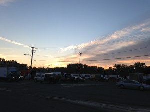 Menands Farmer's Market at dawn.  Trucks filled with imported and local produce lined up, with buyers inspecting the goods